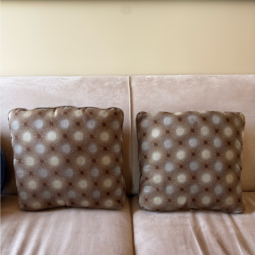 Two Brown Patterned Throw Pillows with Circular Designs